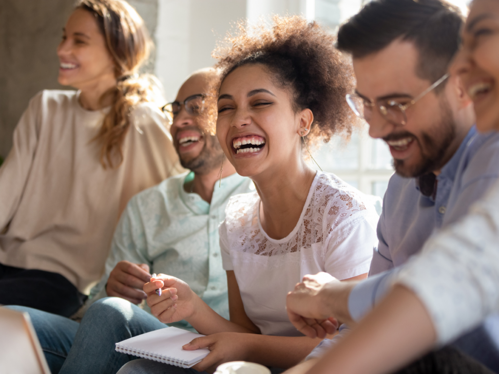Group of adults laughing and connecting while playing printable games, highlighting the social joy and bonding that free printable games bring to any gathering.