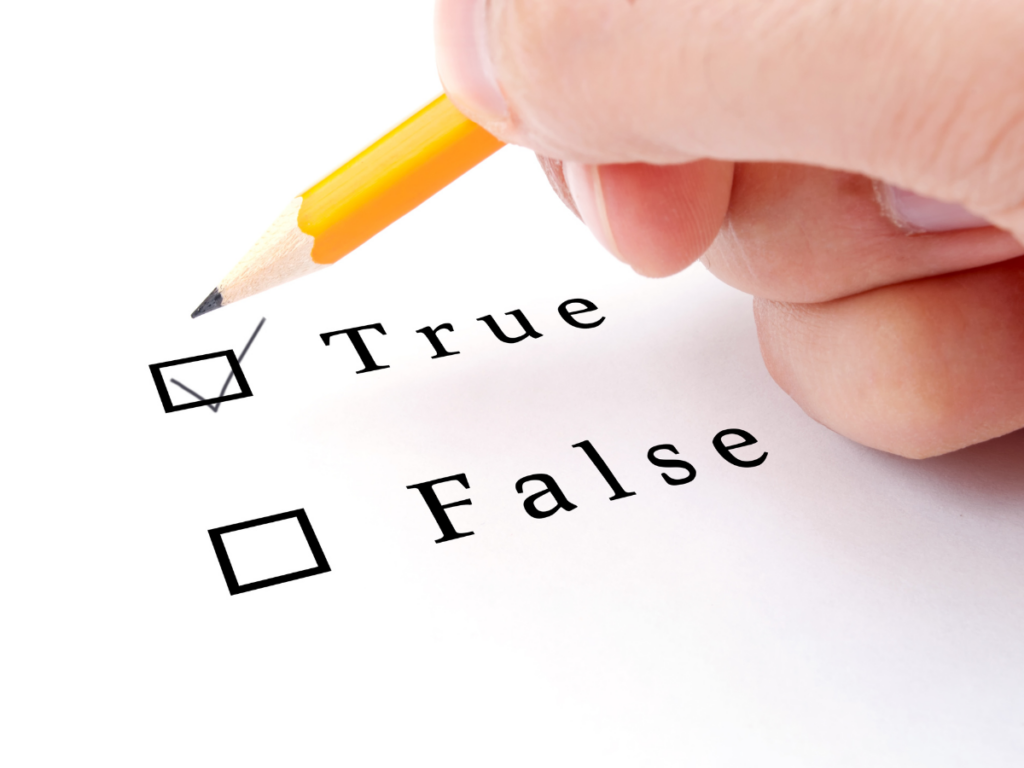 Close-up of a pencil ticking the “True” box on a quiz sheet, representing interactive printable trivia games.