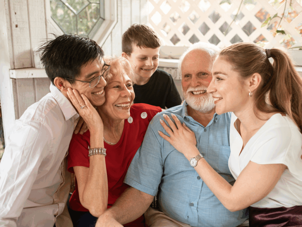 A happy multi-generational family gathered together, enjoying quality time at home—perfect for bonding over instant downloadable party activities for all ages.