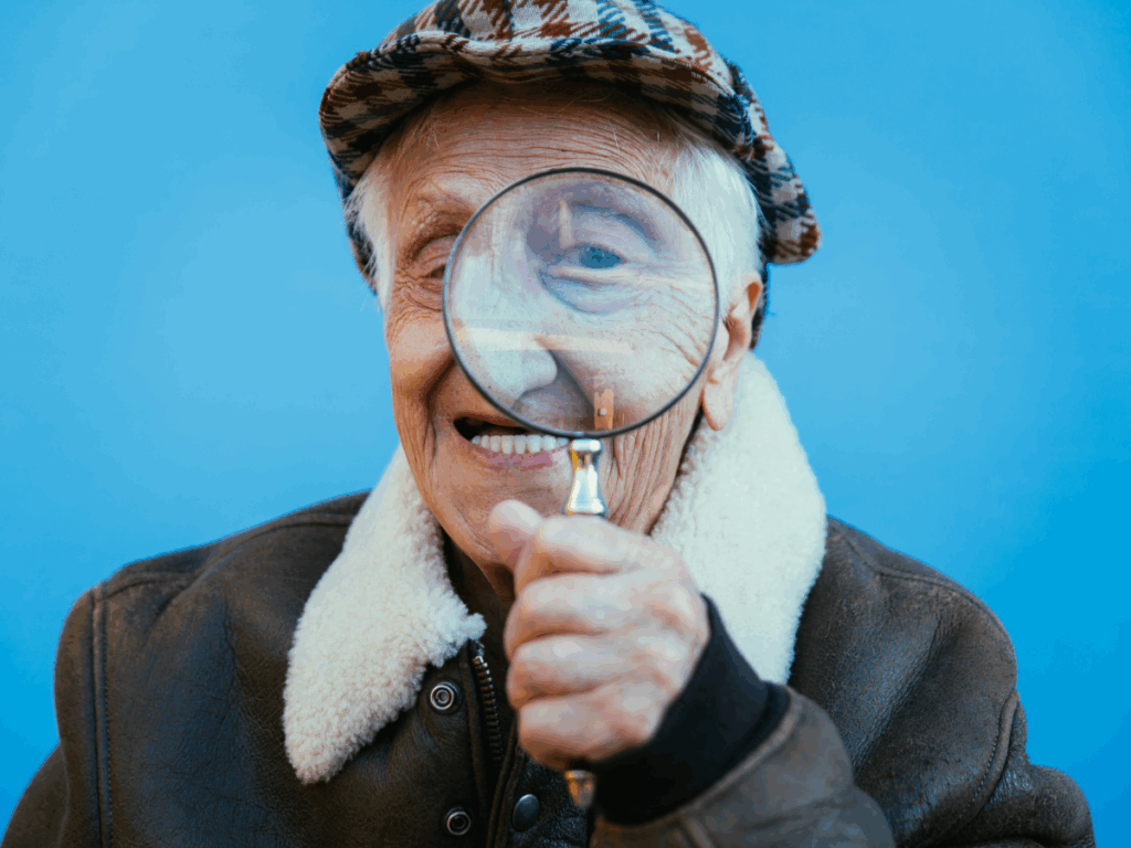 Senior male looking through loop